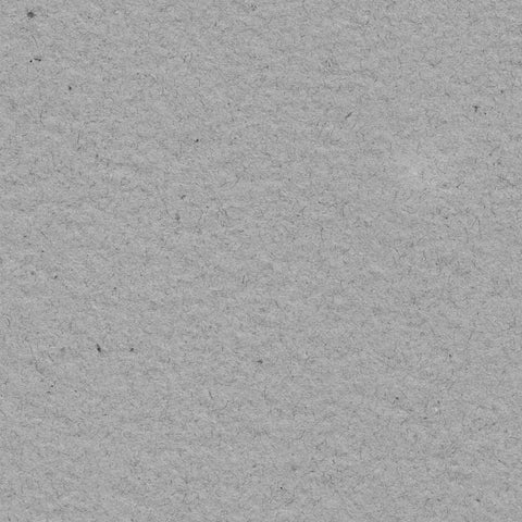 A closeup of charcoal gray deckle edge hand made paper made with 100% recycled wood fiber