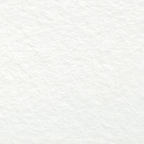 A closeup of white deckle edge hand made paper