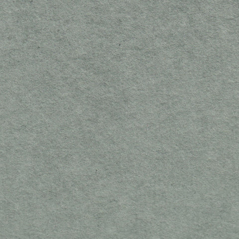 A closeup of earthy green deckle edge hand made paper