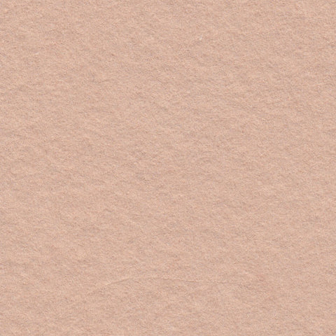 A closeup of dusty warm pink deckle edge hand made paper