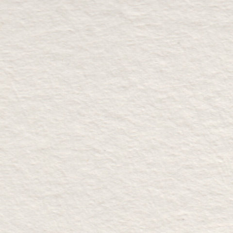 A closeup of warm off-white deckle edge hand made paper