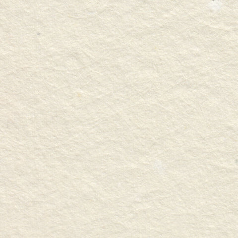 A closeup of creamy off-white deckle edge hand made paper