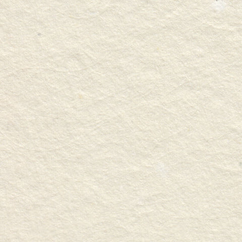 A closeup of creamy off-white deckle edge hand made paper