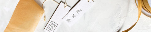 A tag made from handmade paper embedded with wildflower seeds.