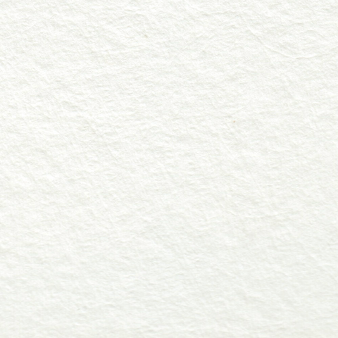 A stack of cotton white deckle edge hand made paper