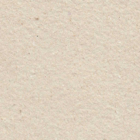 A closeup of light sandy brown deckle edge hand made paper made with cotton and recycled chipboard