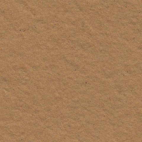 A closeup of warm brown deckle edge hand made paper made from recycled cardboard