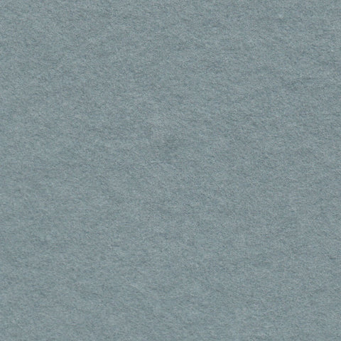 A closeup of dusty blue deckle edge hand made paper