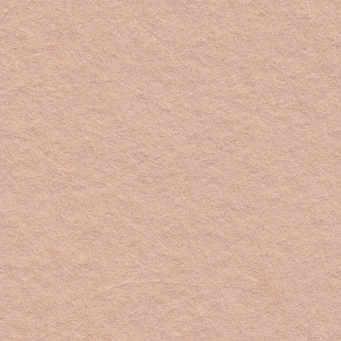 A closeup of dusty warm pink deckle edge hand made paper
