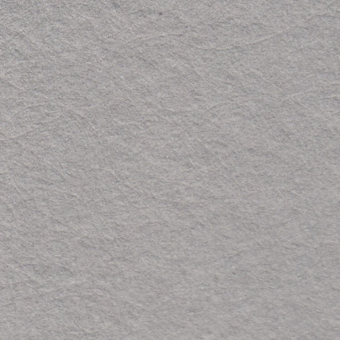 A closeup of stone grey deckle edge hand made paper